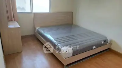 Cozy bedroom with new mattress and wooden flooring, perfect for restful nights.