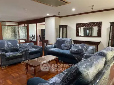 Spacious living room with elegant furniture and wooden flooring, perfect for family gatherings.