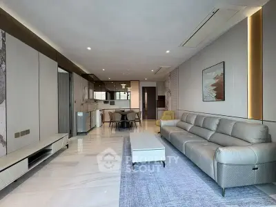 Modern living room with sleek design and open kitchen layout