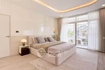 Luxurious bedroom with elegant decor and large windows offering natural light and scenic views.