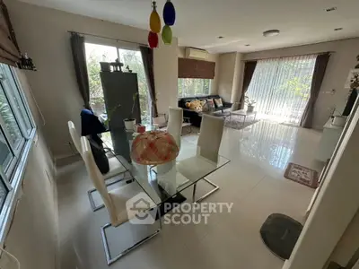 Spacious living room with modern dining area and garden view