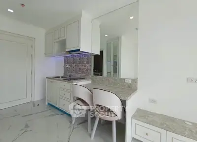 Modern kitchen with sleek countertops and stylish backsplash in a bright, open layout.