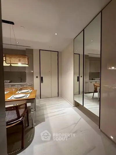 Modern kitchen with elegant dining area and mirrored cabinets