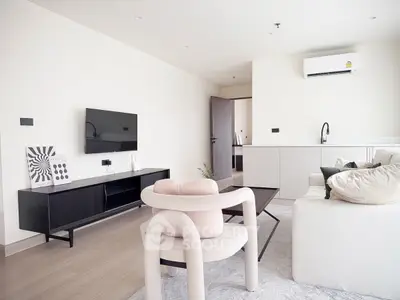 Modern minimalist living room with sleek furniture and wall-mounted TV