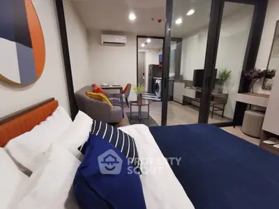 Modern studio apartment with stylish decor and open layout, featuring a cozy bed and chic living area.
