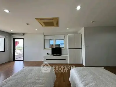 Spacious modern bedroom with balcony access and stylish decor