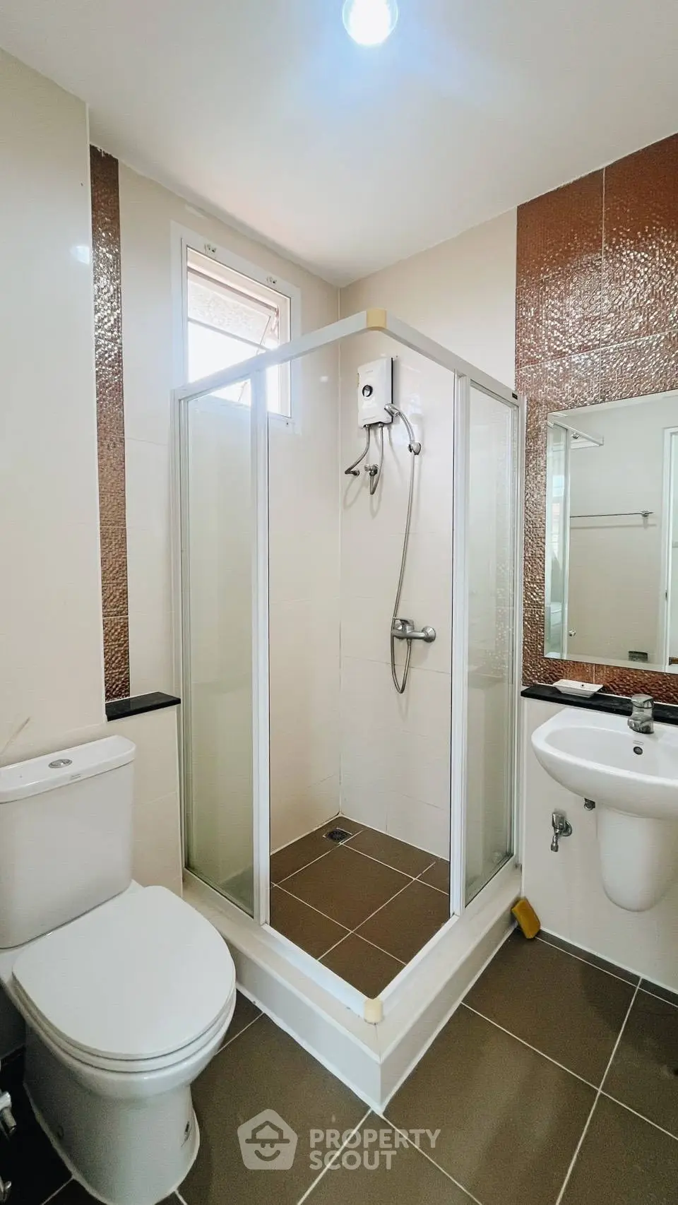 Modern bathroom with glass shower enclosure and sleek fixtures