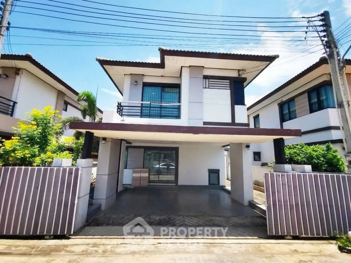 Modern two-story house with spacious driveway and contemporary design in a suburban neighborhood.