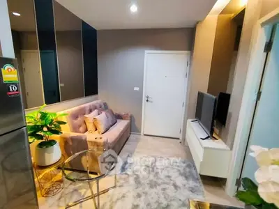 Modern living room with cozy sofa, stylish decor, and sleek TV setup.