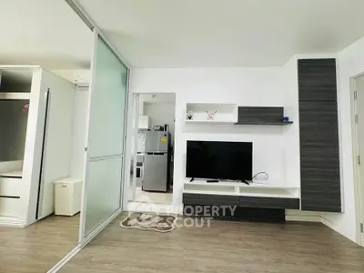 Modern living room with sleek TV unit and sliding glass partition