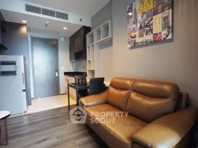 Modern living room with leather sofa and stylish decor in a contemporary apartment.