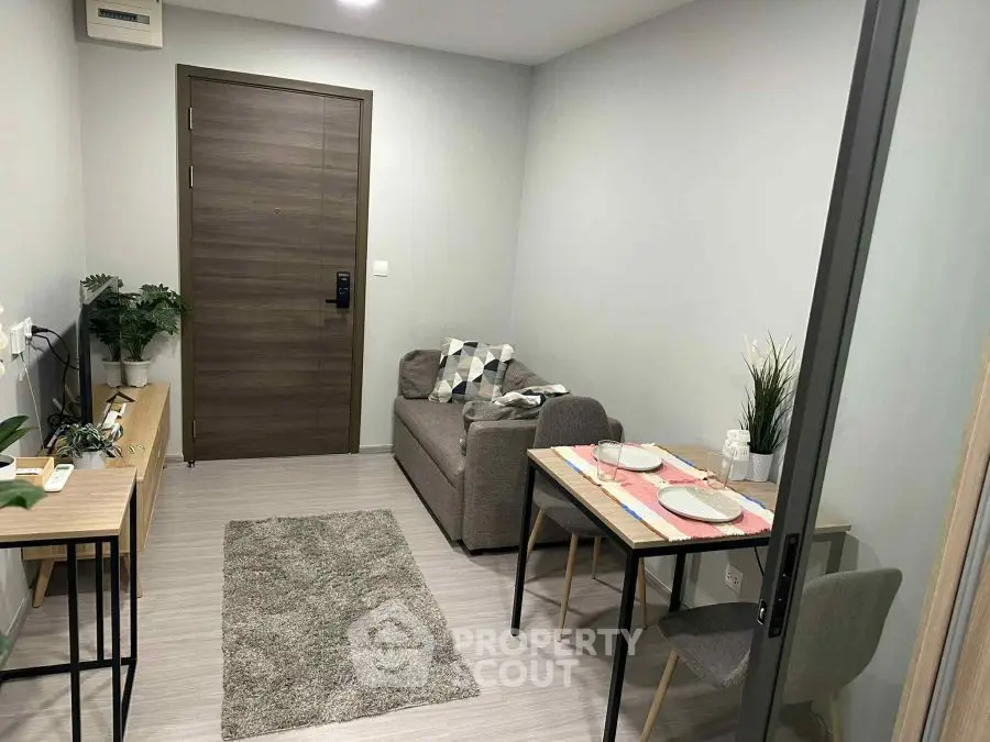 Modern living room with cozy sofa and dining area in stylish apartment.