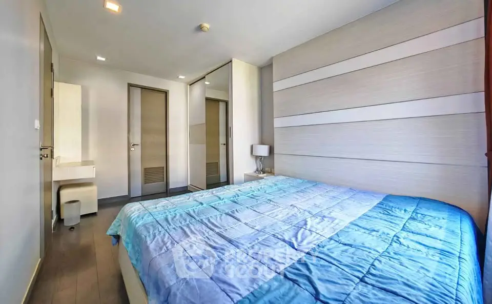 Modern bedroom with stylish decor and ample natural light