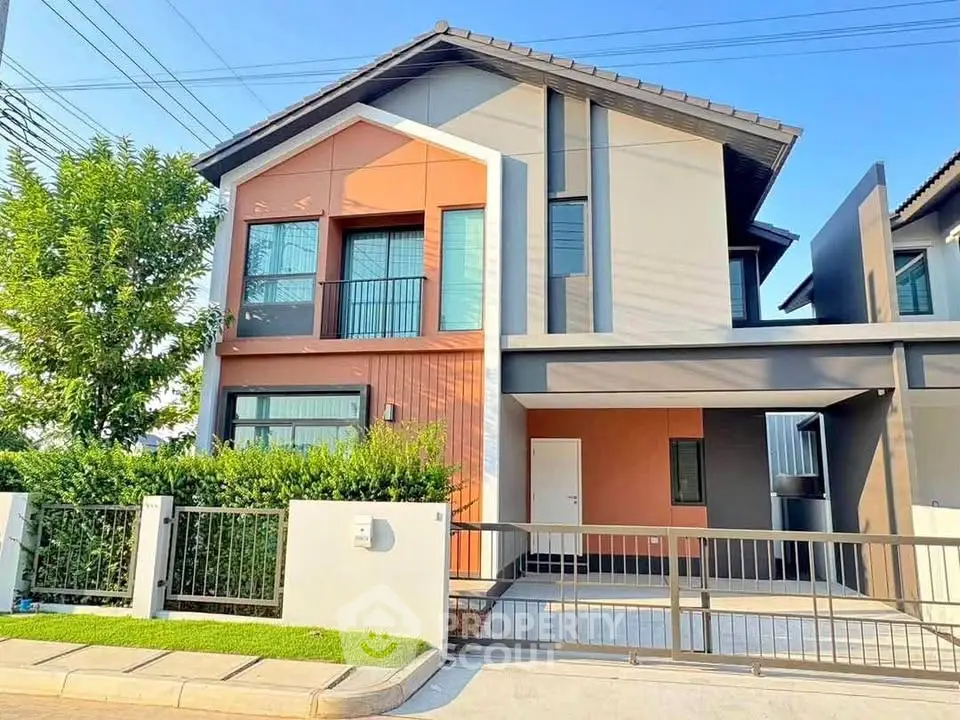 Modern two-story house with sleek design and spacious driveway in a serene neighborhood.