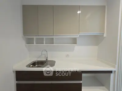 Modern kitchen with sleek cabinetry and stainless steel sink, perfect for contemporary living.