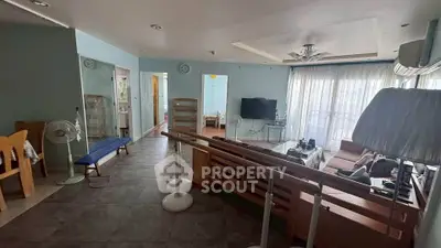 Spacious living room with modern decor and natural light, perfect for family gatherings.