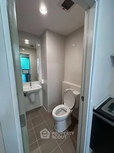 Modern bathroom with sleek fixtures and neutral tiles, perfect for a contemporary home.