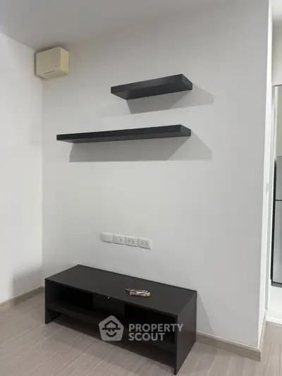 Modern minimalist interior with floating shelves and sleek TV stand