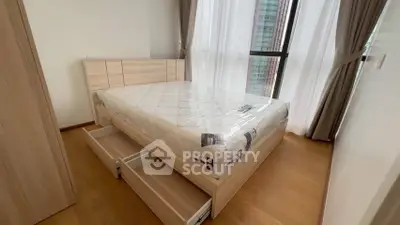 Modern bedroom with wooden flooring and large windows in a high-rise apartment.