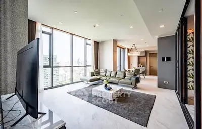 Luxurious modern living room with panoramic city views and elegant furnishings.