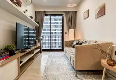 Modern living room with stylish decor and balcony view in a high-rise apartment.