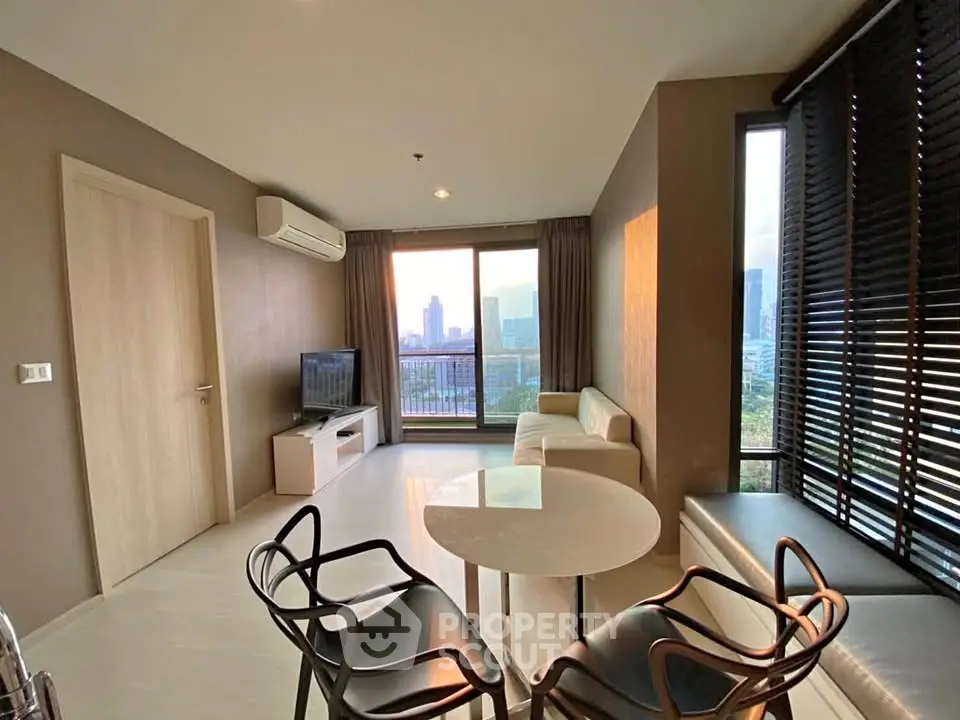Modern living room with city view, stylish furniture, and large windows for natural light.