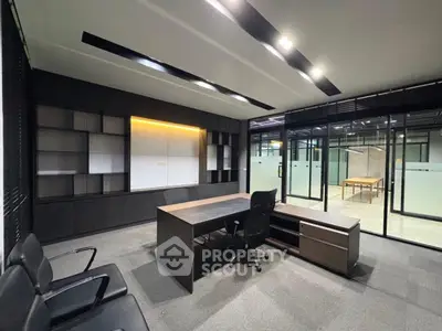 Modern office space with sleek furniture and glass partitions
