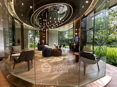 Luxurious modern living room with floor-to-ceiling glass walls and elegant lighting, offering a stunning garden view.