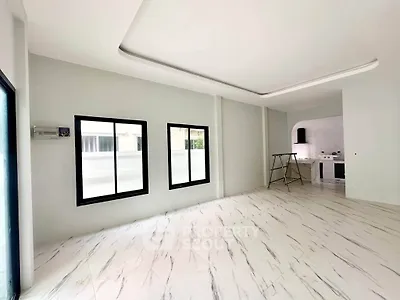 Spacious modern living room with marble flooring and open kitchen layout