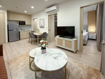 Modern open-plan living room with kitchen, dining area, and stylish decor