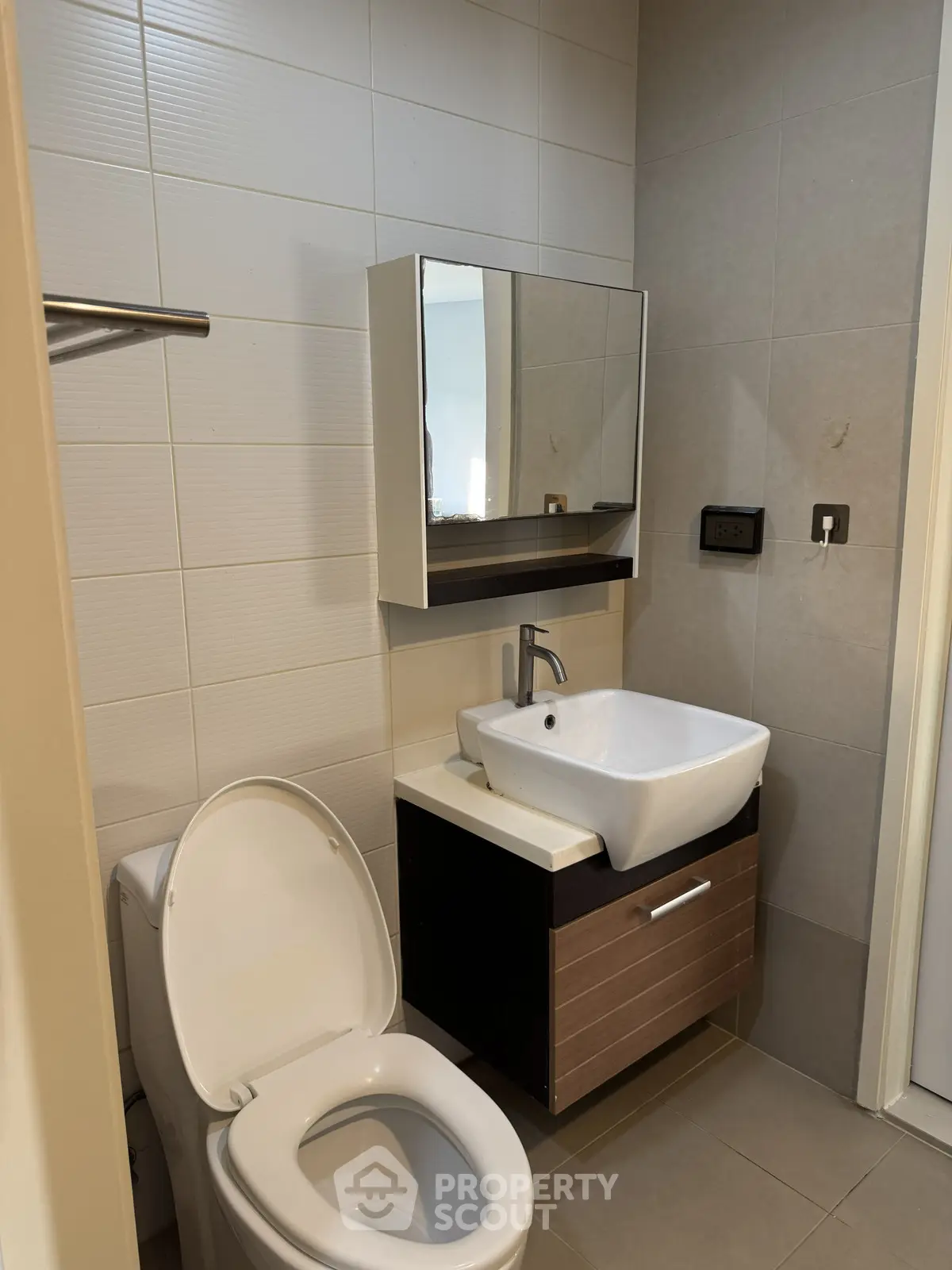 Modern bathroom with sleek sink and toilet in contemporary apartment.