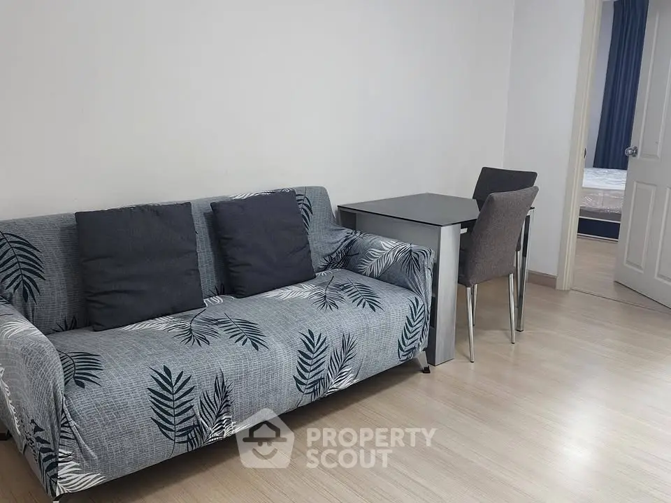 Cozy living room with stylish sofa and dining area in modern apartment.