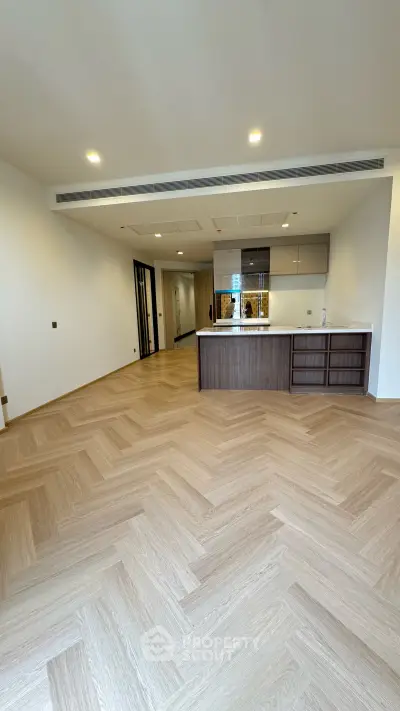 Spacious open-layout kitchen with modern design and elegant wooden flooring