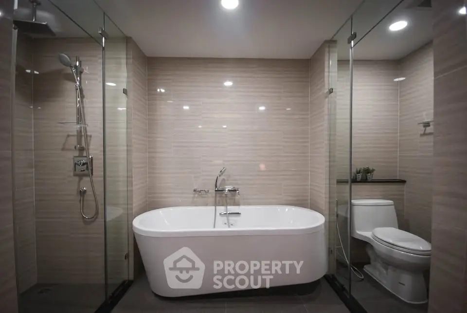 Luxurious modern bathroom with freestanding tub and glass shower enclosure