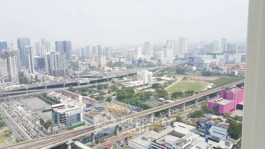 Stunning cityscape view from high-rise building showcasing urban skyline and infrastructure.