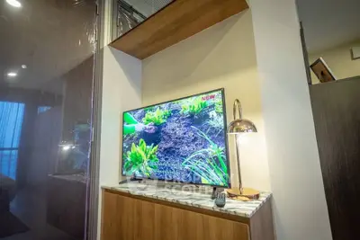 Modern living room with stylish TV setup and elegant lighting