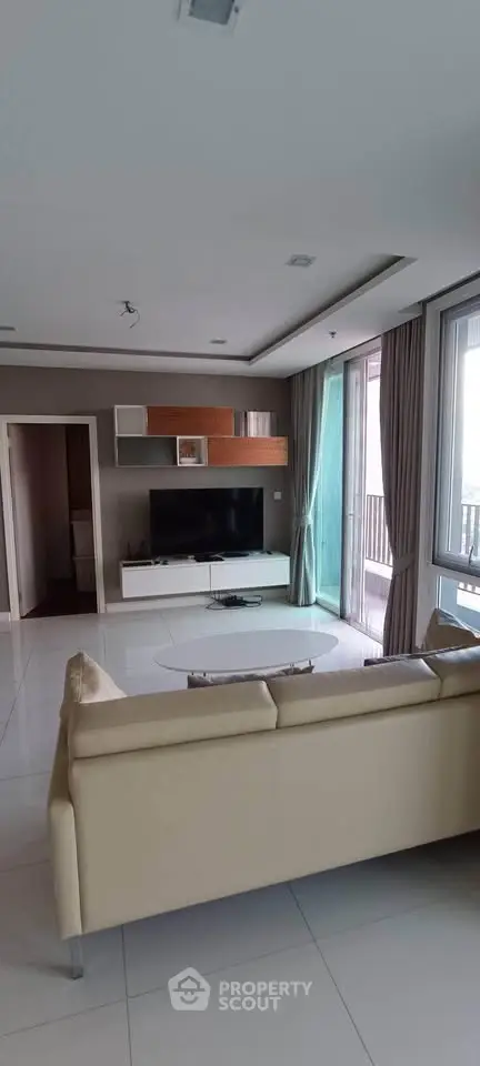 Spacious modern living room with large windows and stylish furniture