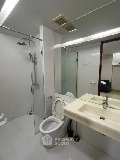 Modern bathroom with glass shower and sleek fixtures