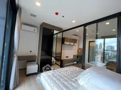 Modern bedroom with city view, featuring large windows and sleek design.