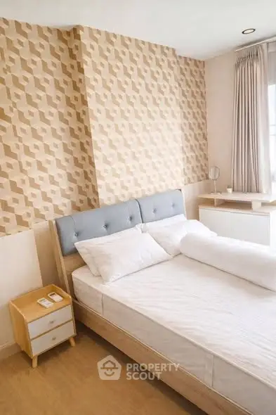 Cozy bedroom with modern decor and stylish wallpaper, perfect for relaxation and comfort.