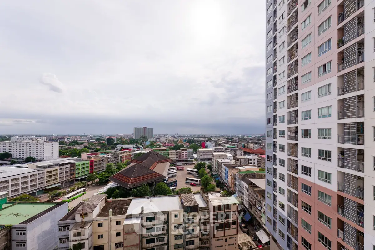 Stunning cityscape view from high-rise building balcony showcasing urban landscape.