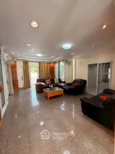 Spacious living room with elegant decor and ample natural light