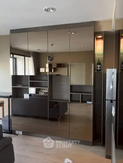 Modern living room with mirrored cabinets and sleek furniture design