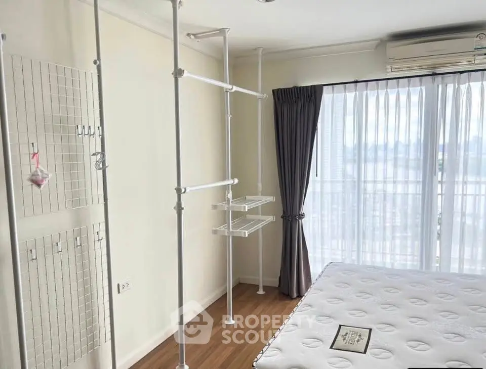 Bright bedroom with large window and modern storage solutions