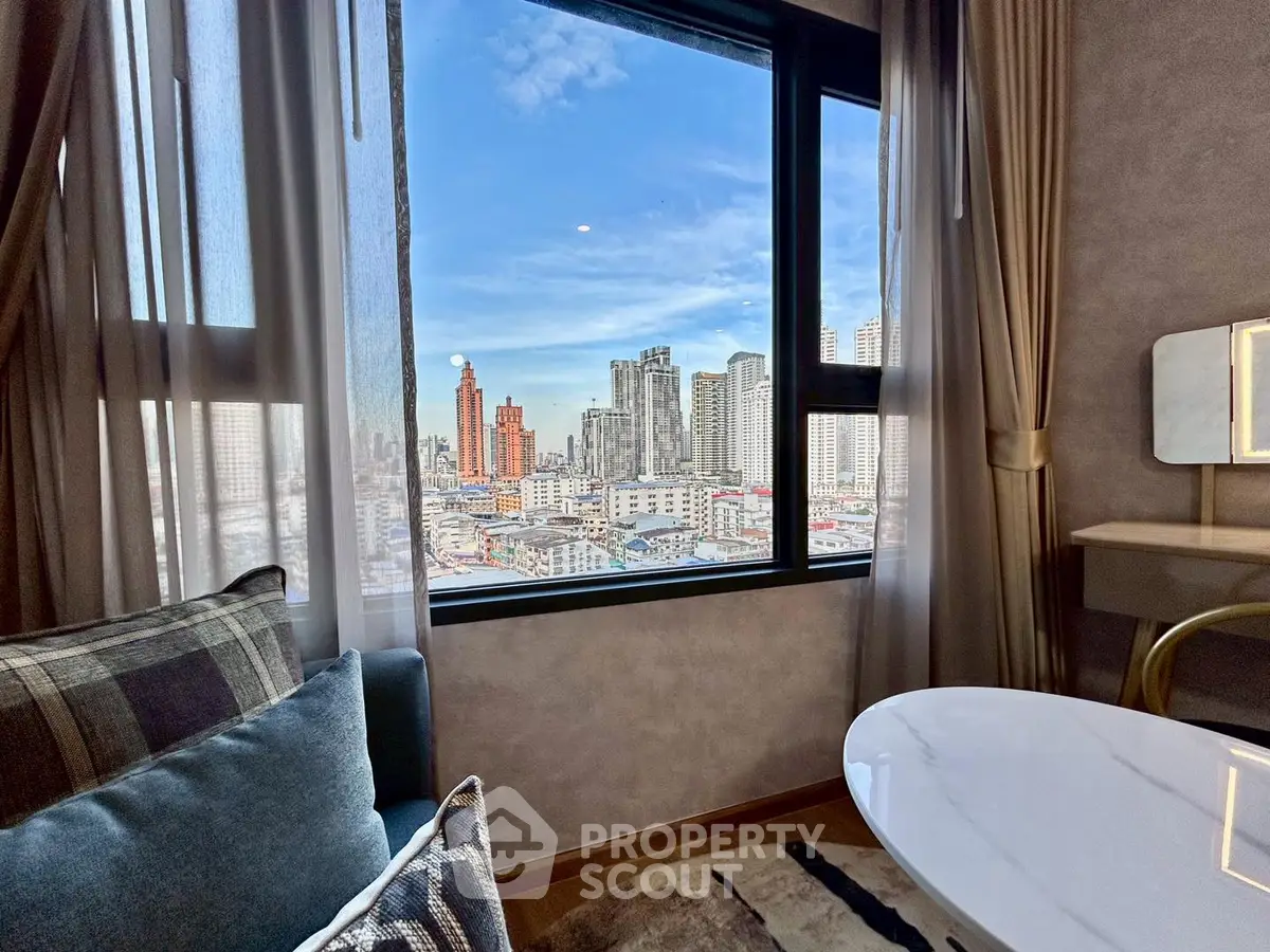 Stunning city view from a cozy living room with modern decor and large window.