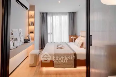 Modern bedroom with stylish decor and natural light, featuring a cozy bed and elegant furnishings.