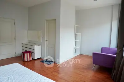 Spacious bedroom with modern decor and wooden flooring