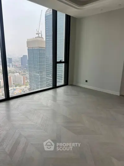 Spacious high-rise apartment with stunning city view and elegant flooring.