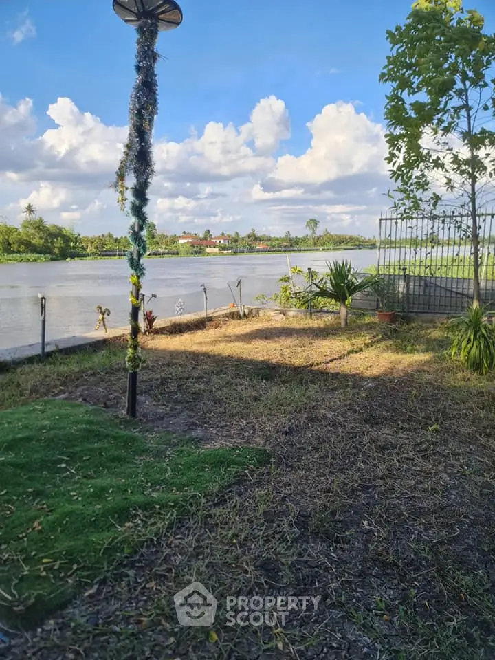 Scenic riverside garden with lush greenery and serene water view, perfect for relaxation and outdoor enjoyment.