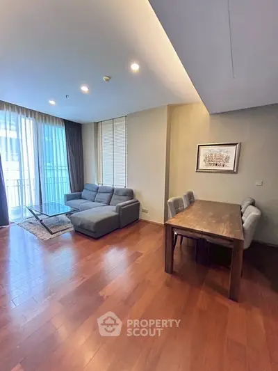 Spacious living room with modern furniture and large windows in a contemporary apartment.